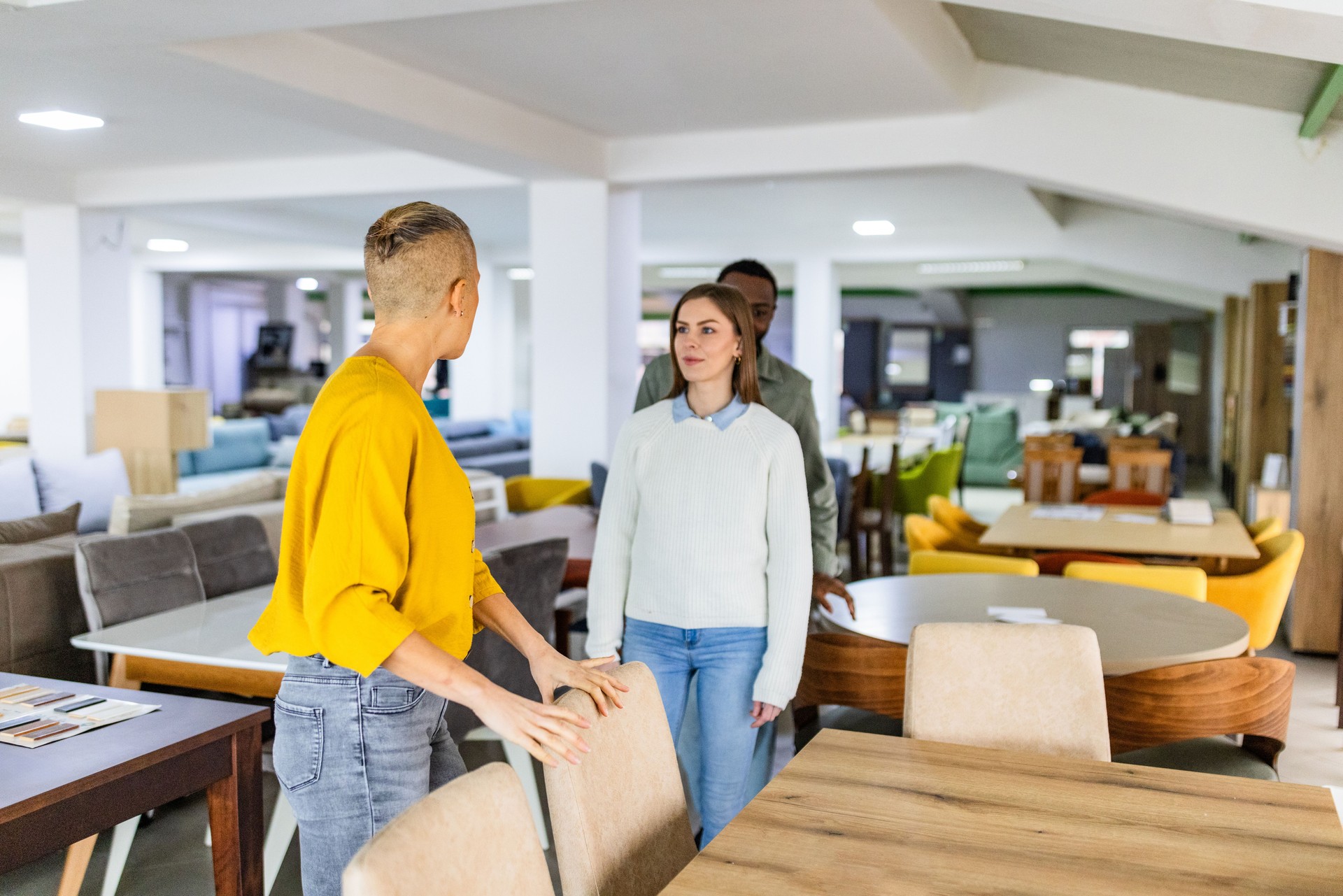 Discussing furniture styles at a modern showroom visit.
